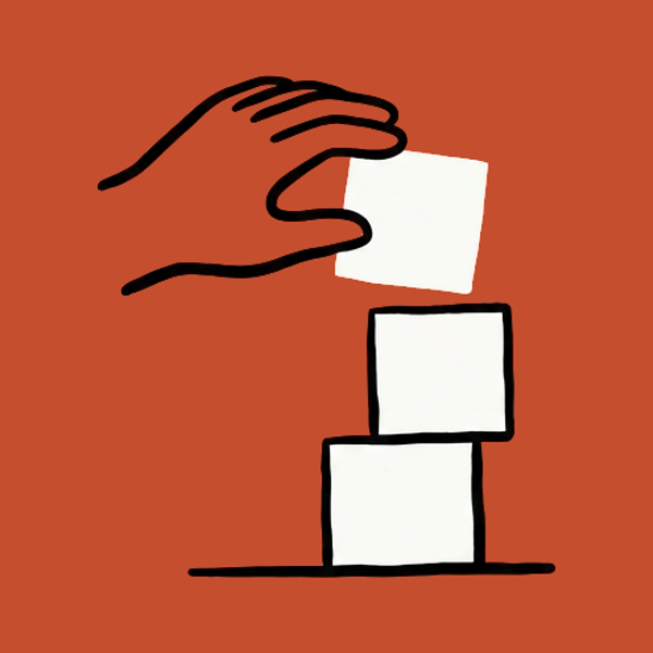 A hand stacking building blocks.